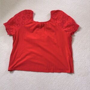 Orange jersey top with eyelet puff sleeves